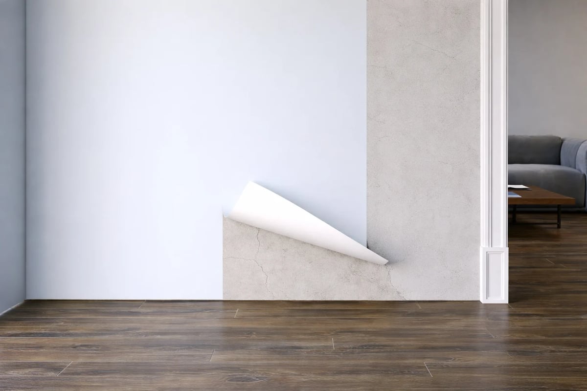 Modern minimalist interior with white curved wall feature, wooden flooring, and doorway leading to bedroom with gray furniture